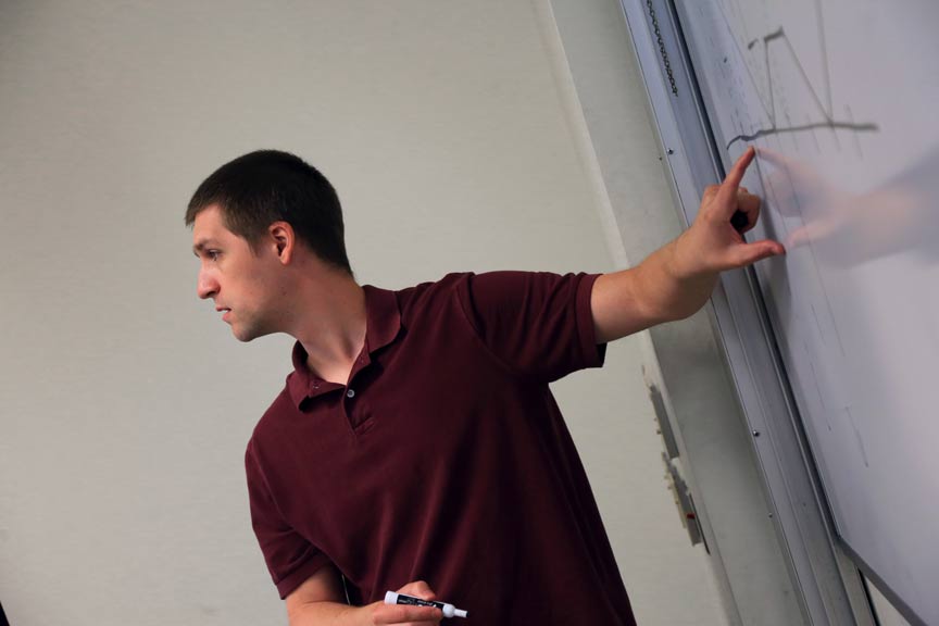 image of professor using a whiteboard to teach mathematics