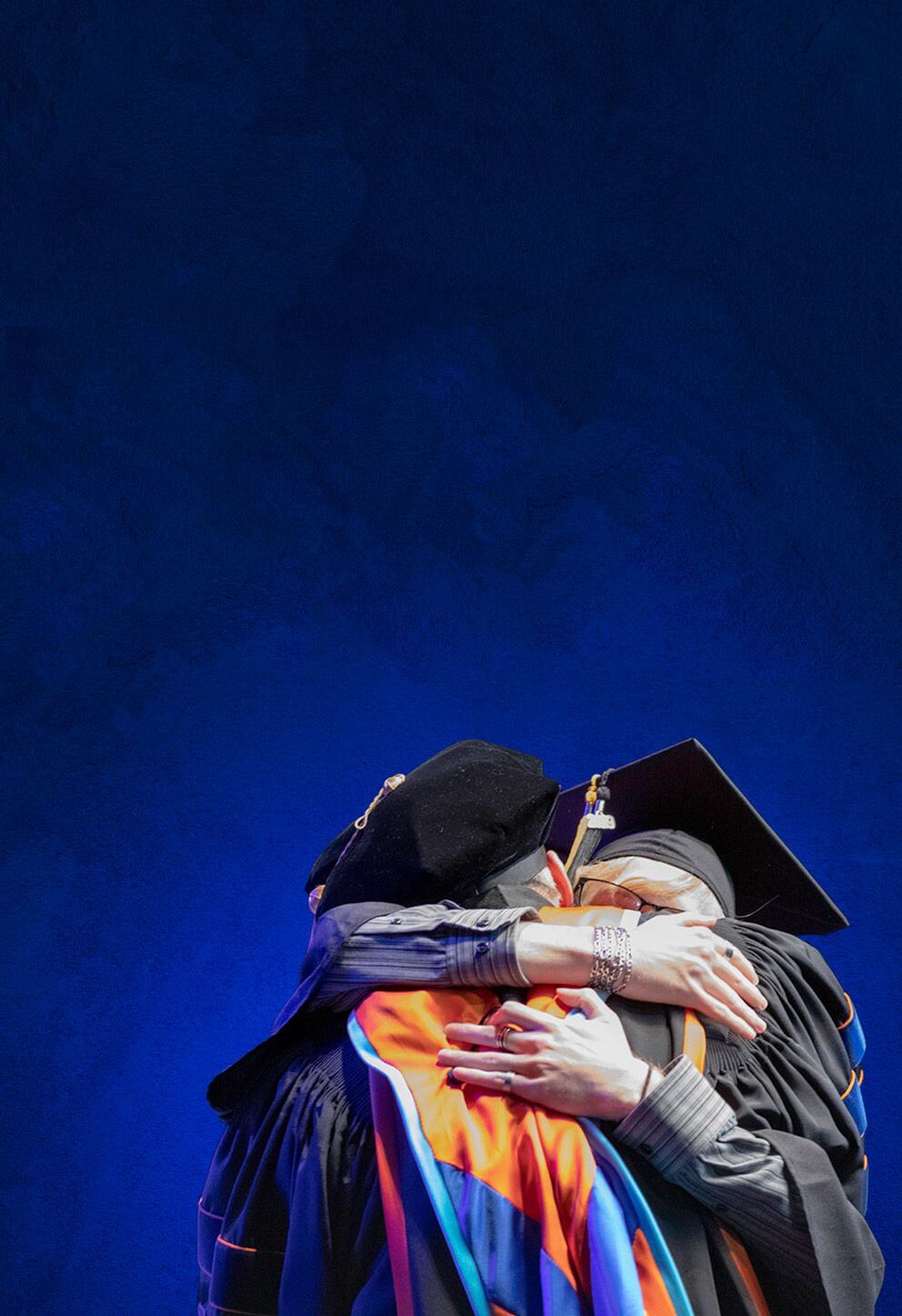Older female graduate hugging person granting diploma