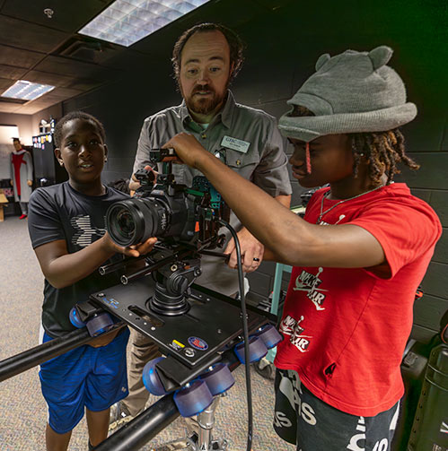 Campers being shown video tech by film instructor