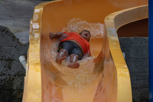 Camper sliding down water slide