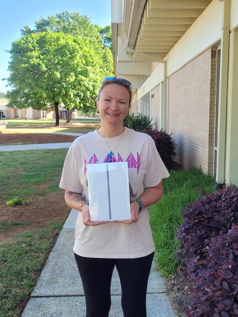 Grand Prize Winner Sam Hudgins collects her prize: a 2022 iPad!