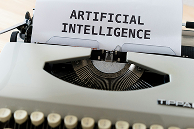 "Artificial Intelligence" written on a white piece of paper in a typewriter