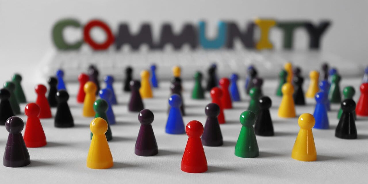 colored game pieces signifying collaboration with the word community in background