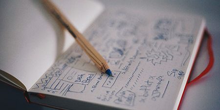blue pencil on brainstorm notebook