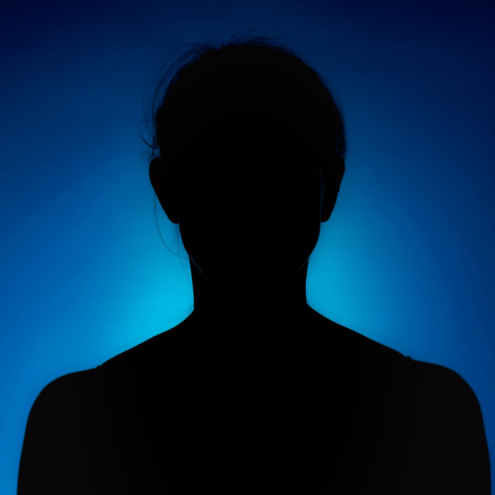 Cleanly defined silhouette of a person against a blue background