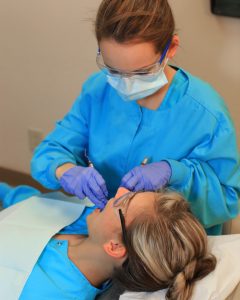dental hygienist with patient
