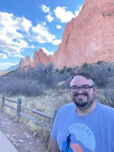 scott standing in front of a mountain