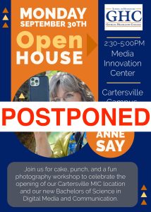 Orange and blue flyer with a banner across the image that says "POSTPONED" in red letters. 