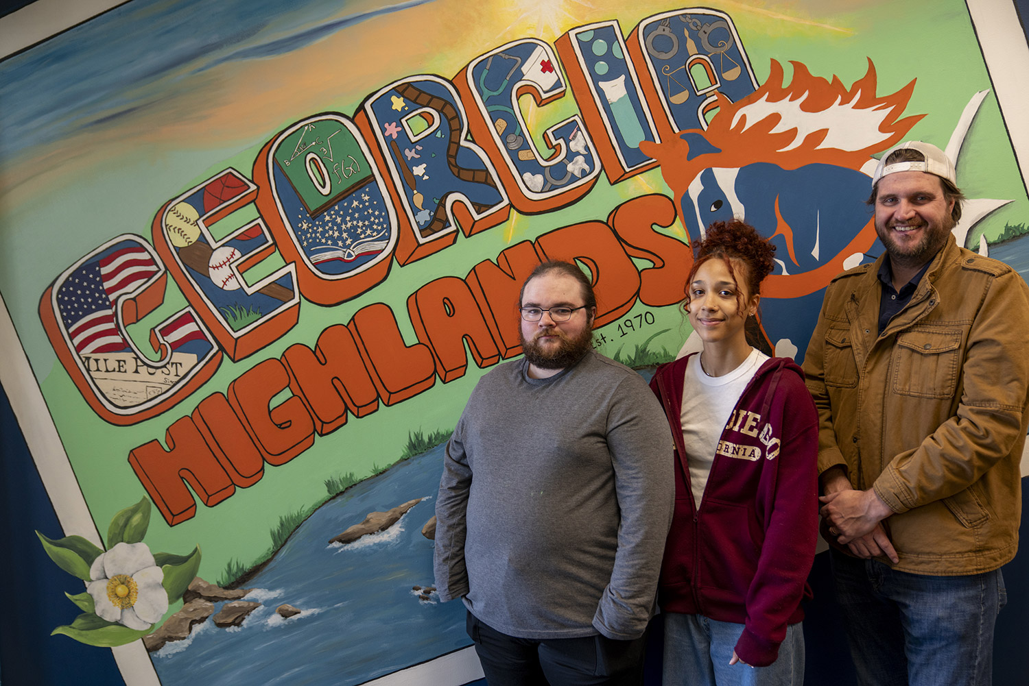 Students stand in front of the mural