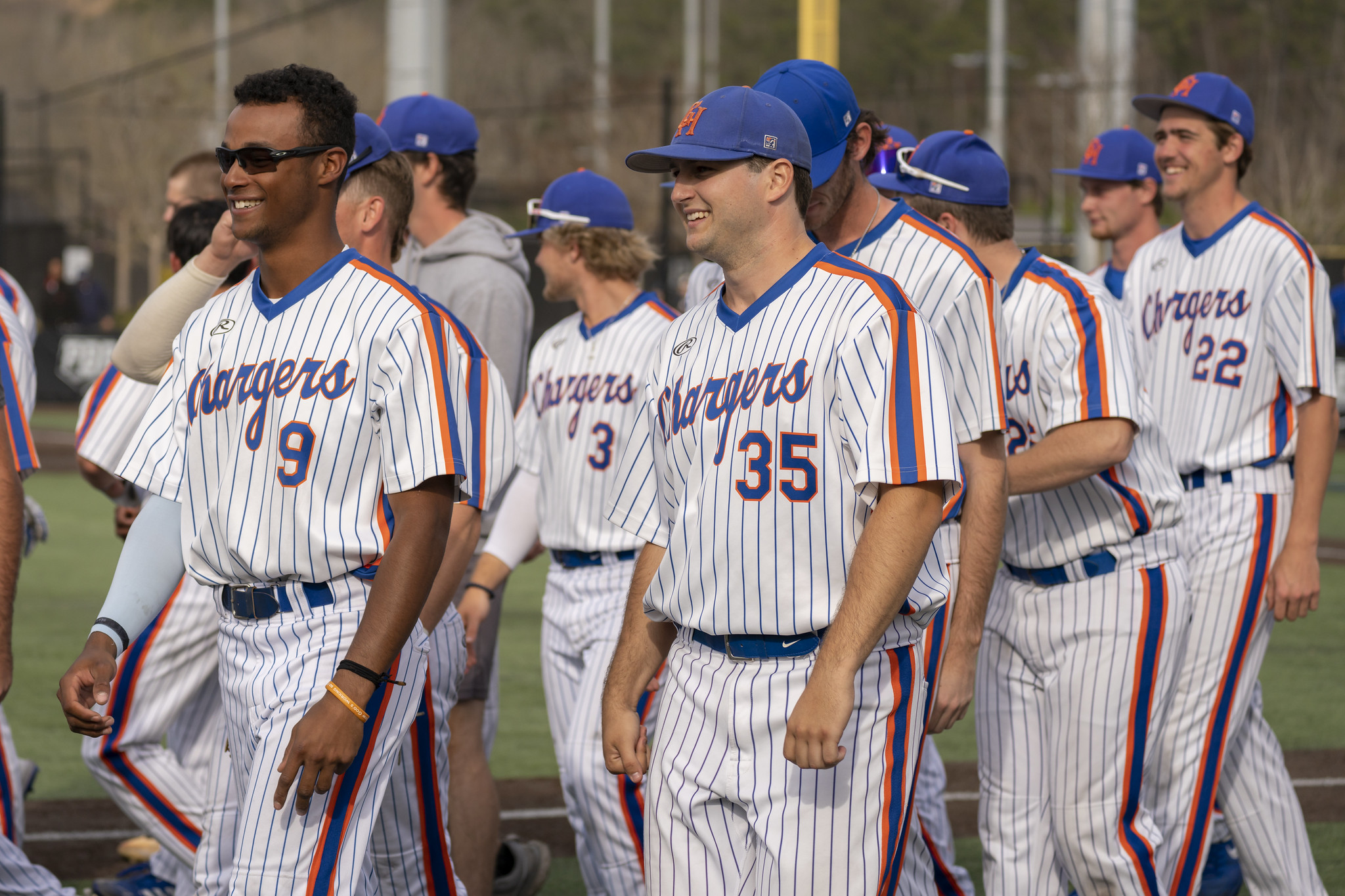 Several baseball players taking to the field to celebrate a win.