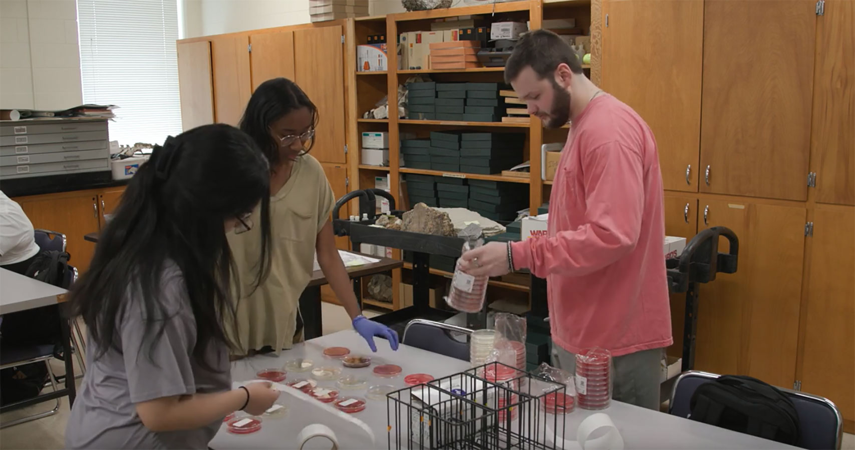 group of students working in a science lab with test tubes