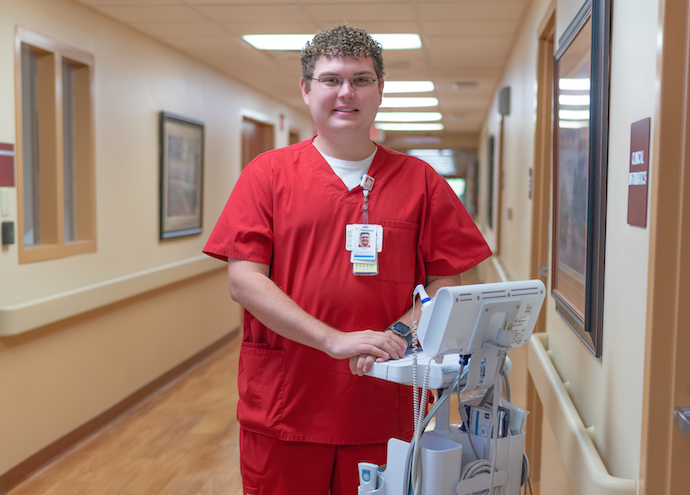 Dillan standing in hospital setting