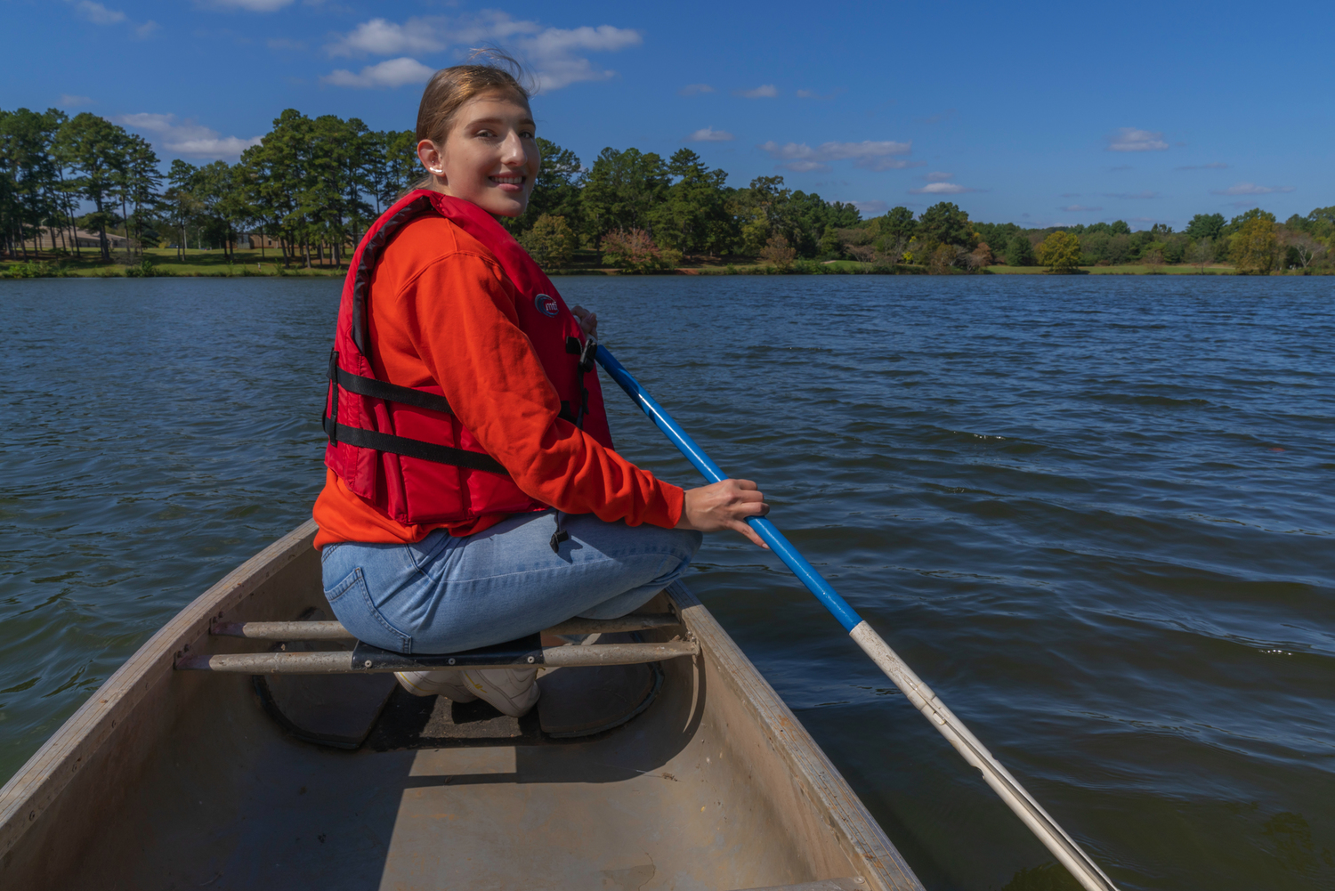 female student rowing in a canoe