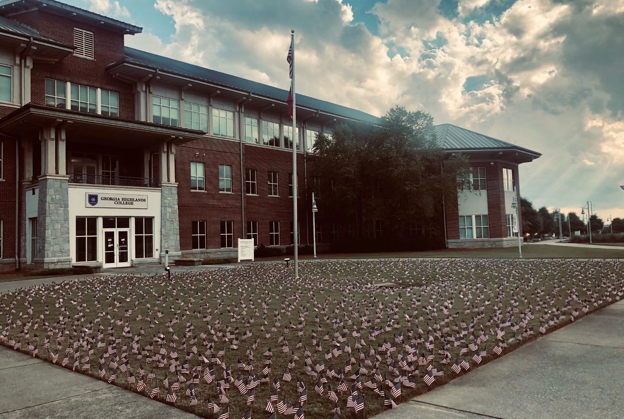 The flags on the lawn outside of campus