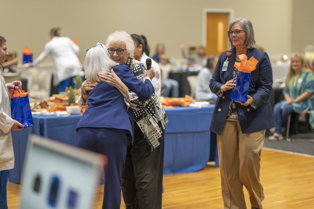 two nurses hugging in celebration of 50 years of nursing at ghc
