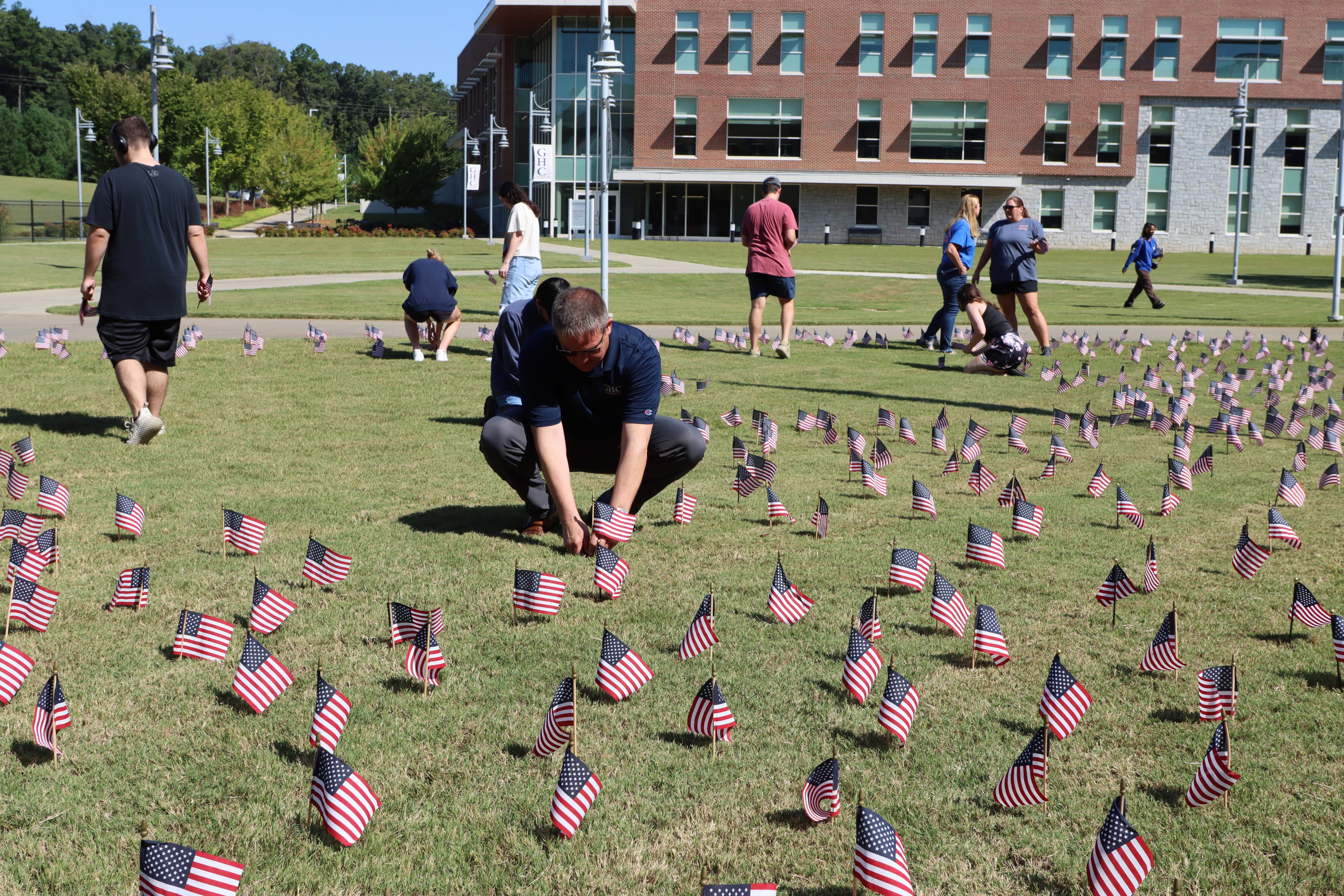 GHC President Dr. Mike Hobbs placing flags.