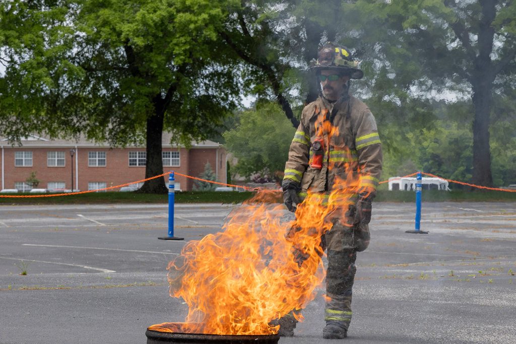 A firefighter starts a controlled burn at the GHC nursing disaster simulation.