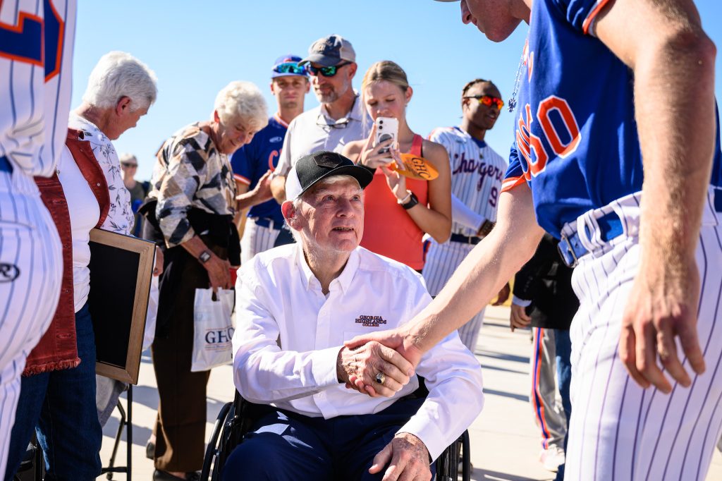 Cdr. Robery Bently USN (Ret) shaking hands with a Charger baseball player