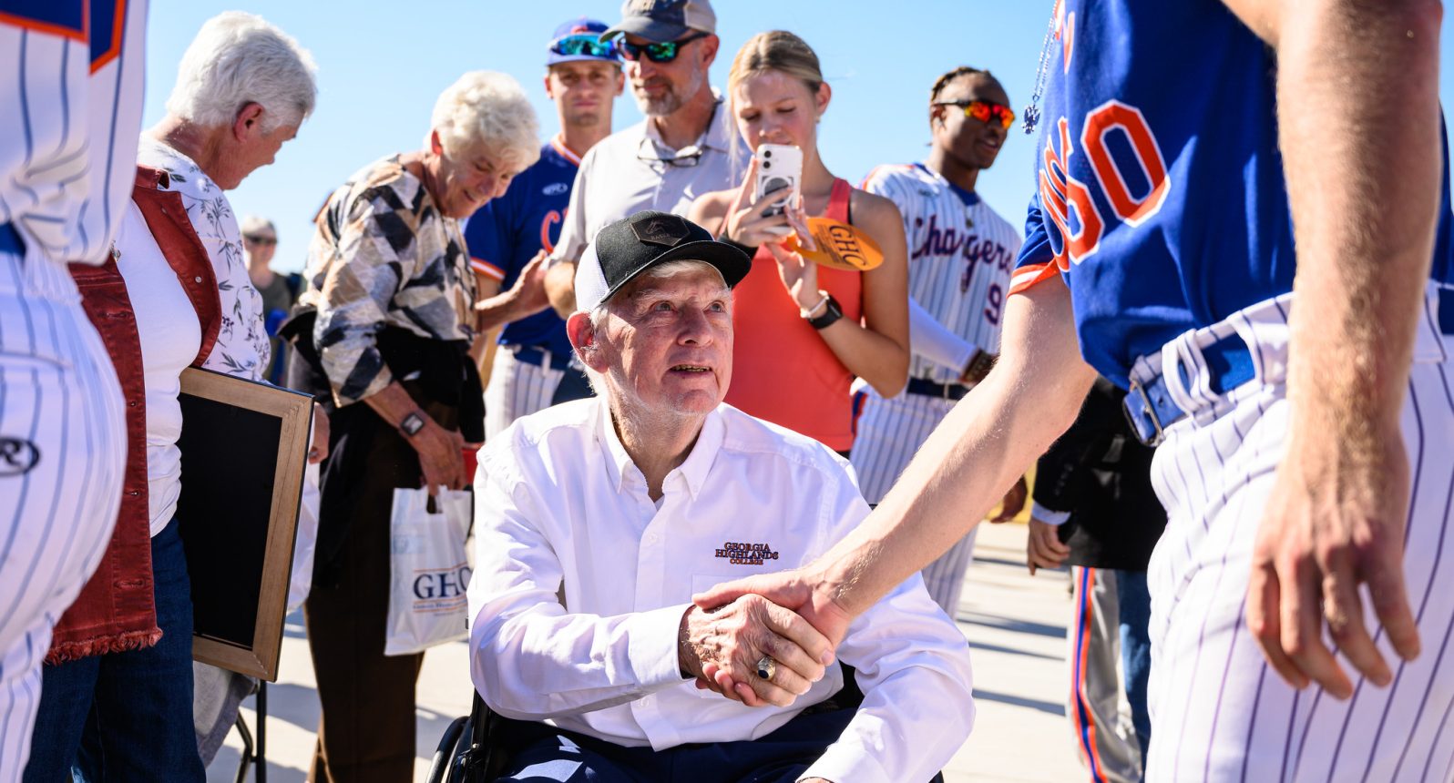 Cdr. Robery Bently USN (Ret) shaking hands with a Charger baseball player