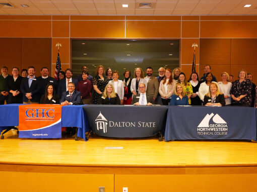 Group photo of articulation agreement signing