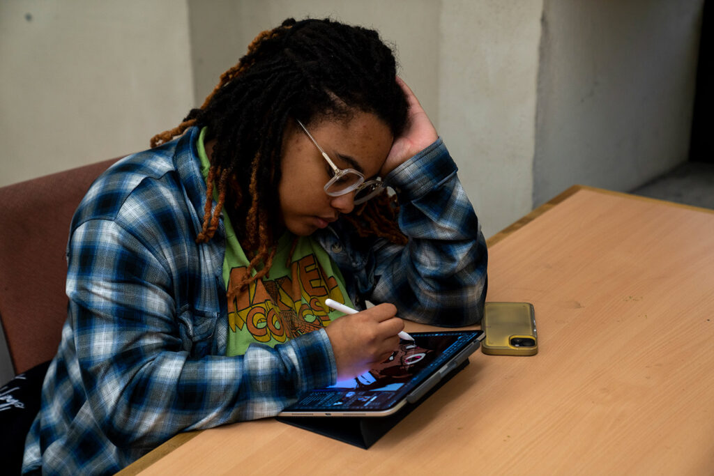 GHC student works on her tablet.