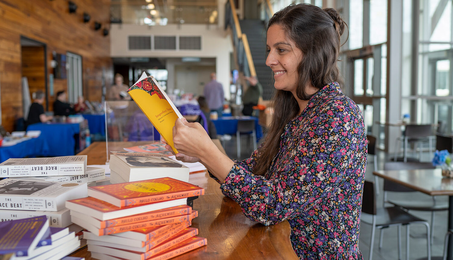 Image of woman reading a book at the Highlands Writers Conference