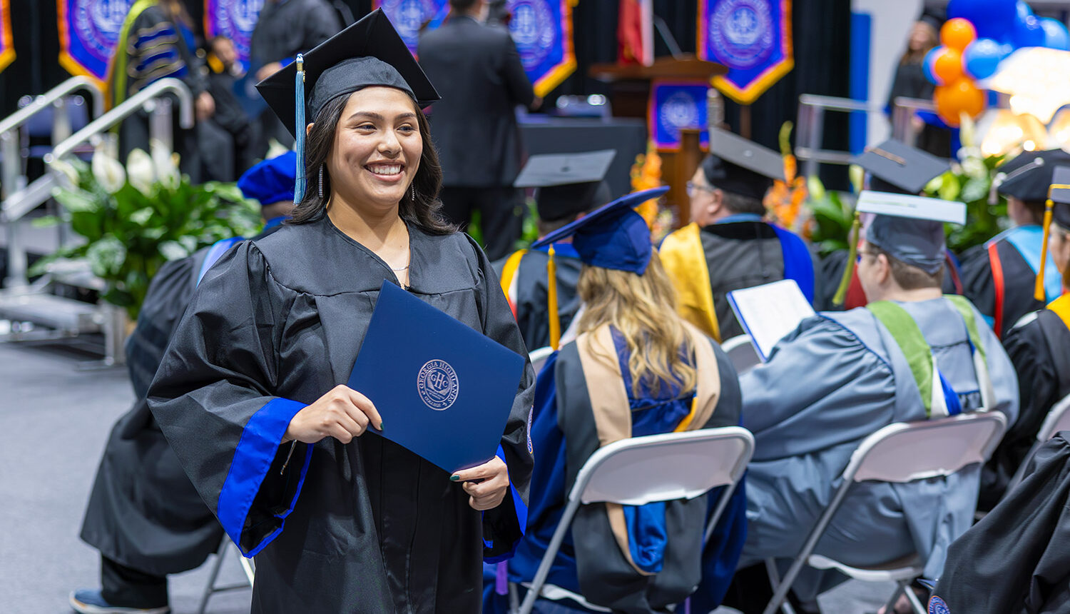Student at commencement with degree