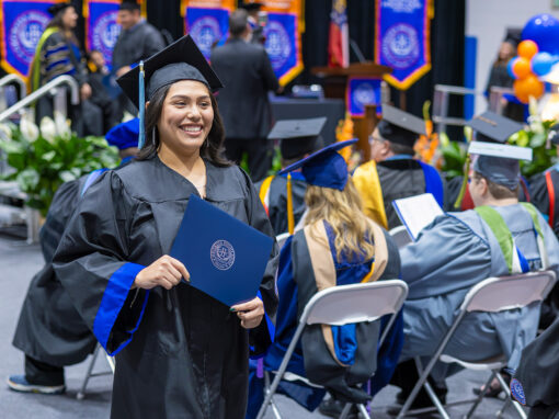Student at commencement with degree