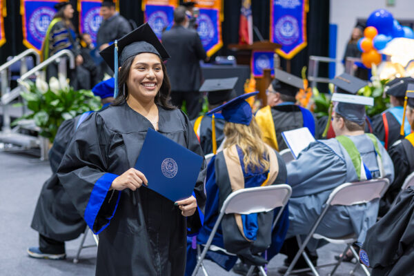 Student at commencement with degree