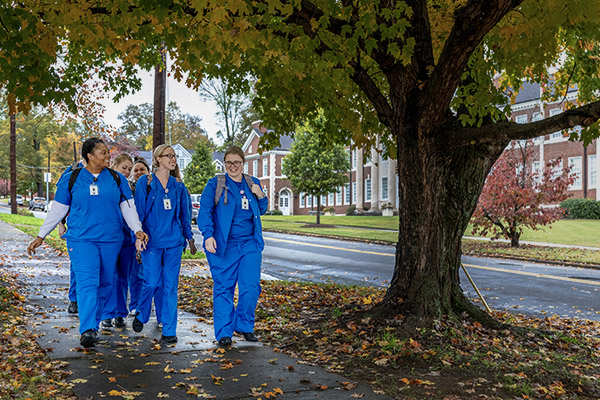 nursing students walking in front of Heritage Hall