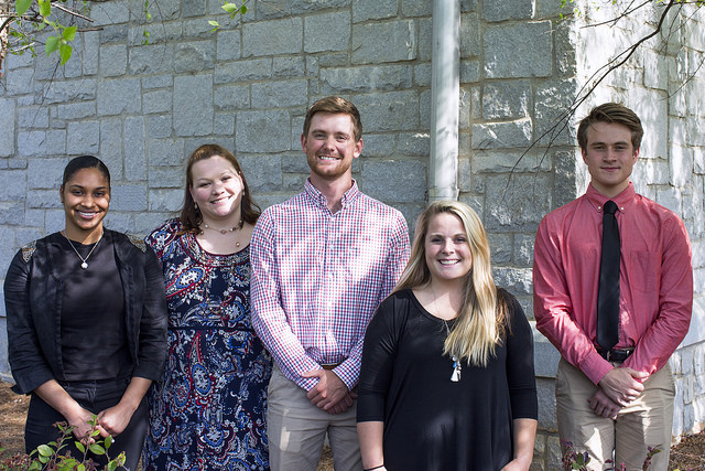 Picture of students standing and smiling