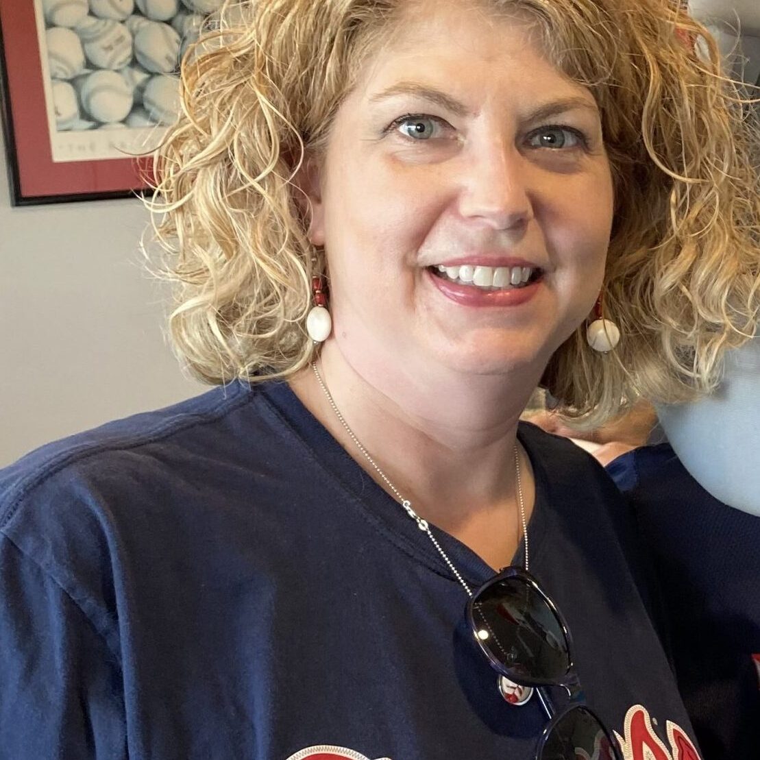 Pic for WC- Wheeler Woman with curly hair smiling, wearing a braves shirt