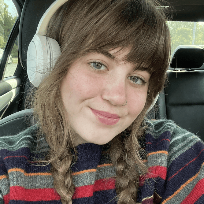 Woman with braided hair and striped sweater