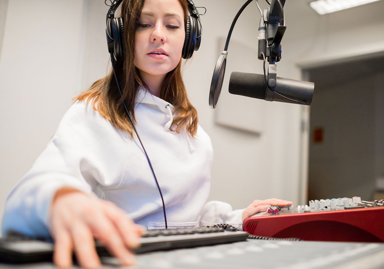 radion jockey wearing headphones in the studio