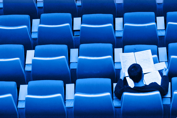 student sitting alone in classroom auditorium