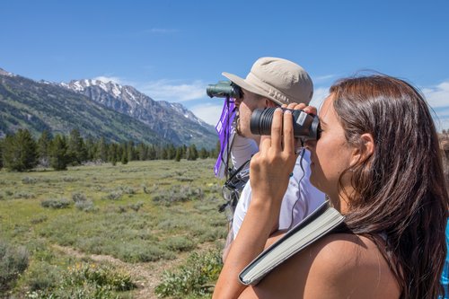 Students looking through binoculars.